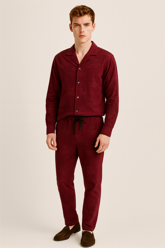 Man wearing a burgundy pajama set on a beige background